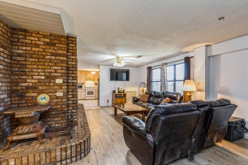 6246 Holloway Road Baker, FL 32531 - Photo 23 of 52 a living room with furniture and a flat screen tv
