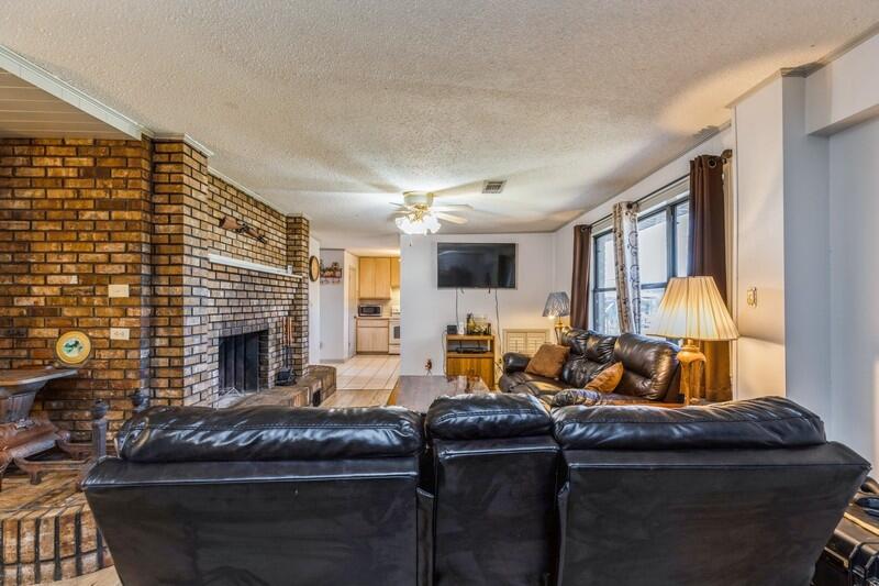 6246 Holloway Road Baker, FL 32531 - Photo 24 of 52 a living room with furniture fireplace and a fireplace