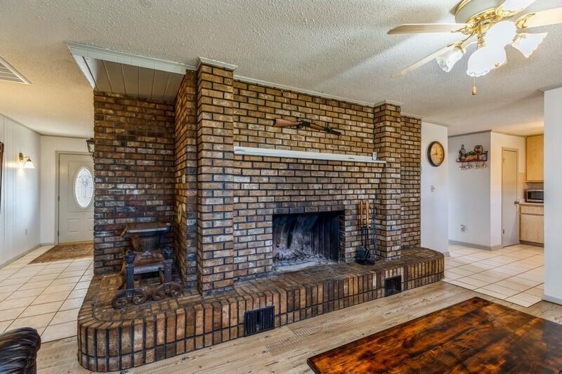 6246 Holloway Road Baker, FL 32531 - Photo 25 of 52 a living room with furniture a flat screen tv and a fireplace