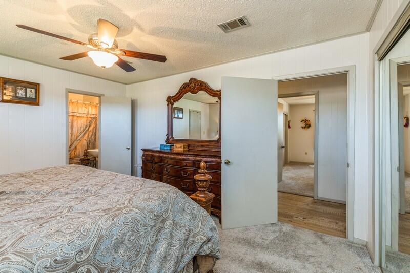 6246 Holloway Road Baker, FL 32531 - Photo 26 of 52 a bedroom with a bed and a chandelier