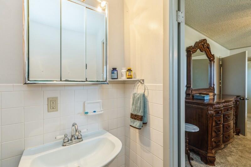 6246 Holloway Road Baker, FL 32531 - Photo 29 of 52 a bathroom with a sink and a mirror