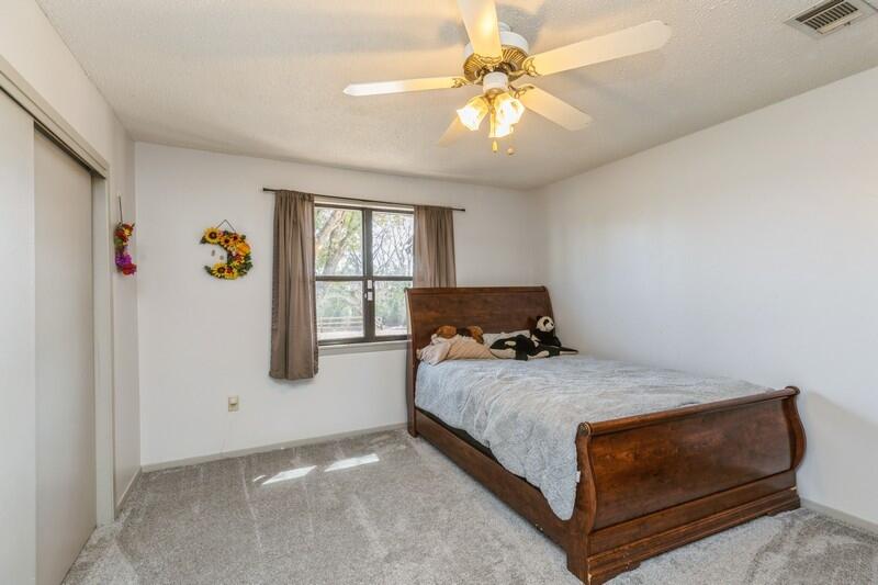 6246 Holloway Road Baker, FL 32531 - Photo 30 of 52 a bedroom with a bed and a chandelier