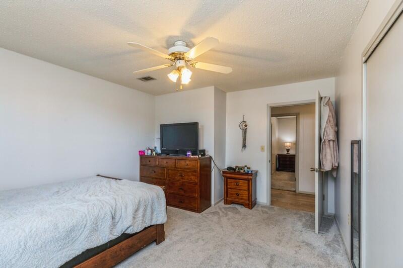6246 Holloway Road Baker, FL 32531 - Photo 31 of 52 a bedroom with a bed and a chandelier