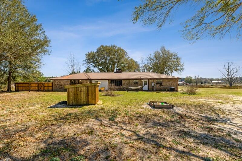 6246 Holloway Road Baker, FL 32531 - Photo 37 of 52 a view of a swimming pool with an outdoor seating and a yard