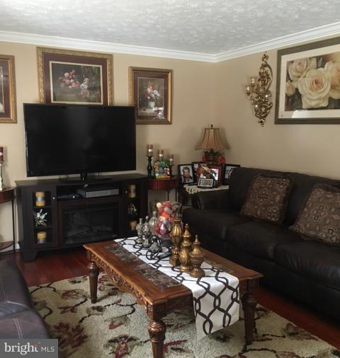 1403 Bretton View Road Annapolis, MD 21409 - Photo 16 of 30 a living room with furniture and a flat screen tv