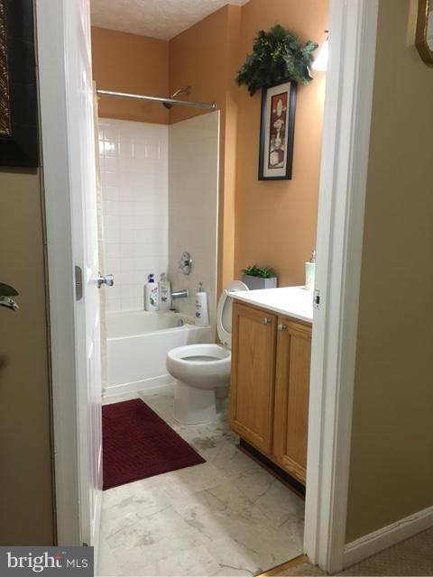 1403 Bretton View Road Annapolis, MD 21409 - Photo 3 of 30 a bathroom with a toilet a sink and mirror