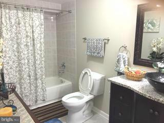 1403 Bretton View Road Annapolis, MD 21409 - Photo 23 of 30 a bathroom with a granite countertop sink toilet and shower