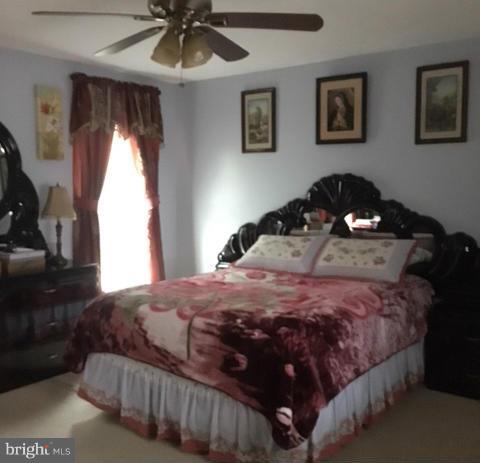 1403 Bretton View Road Annapolis, MD 21409 - Photo 5 of 30 a bedroom with a bed and a chandelier