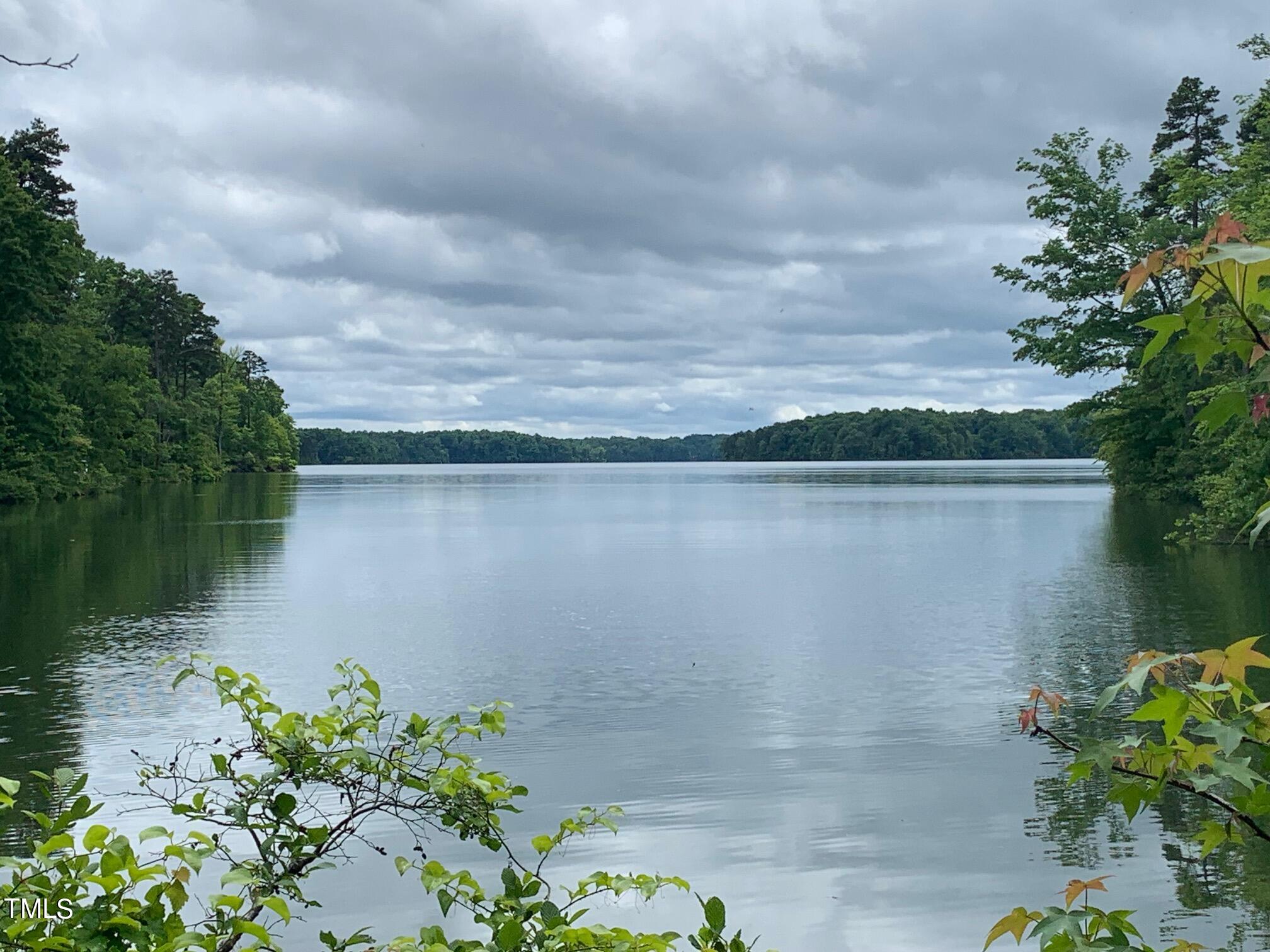 0 New Mayo Drive Roxboro, NC 27574 - Photo 1 of 9 a backyard of a house with lots of green space and lake view