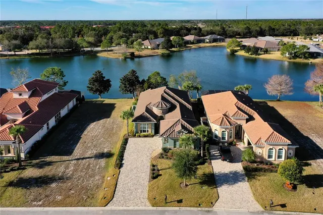 an aerial view of a house with a lake view