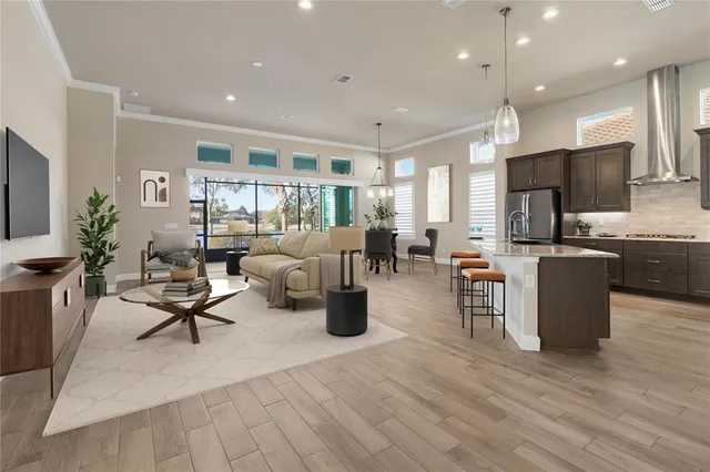 a kitchen with kitchen island granite countertop a stove a sink and refrigerator