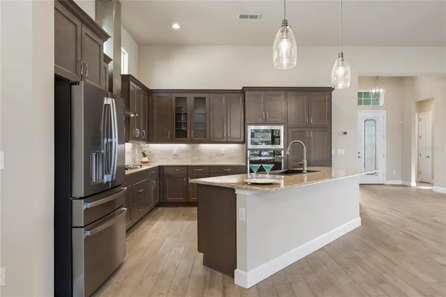 a kitchen with granite countertop a sink and cabinets