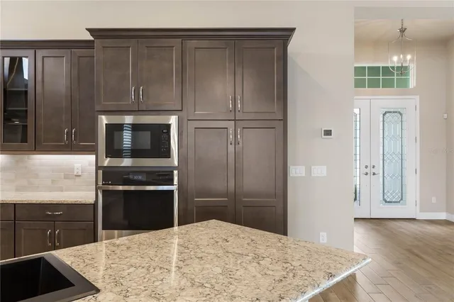 a kitchen with stainless steel appliances granite countertop a sink and a stove