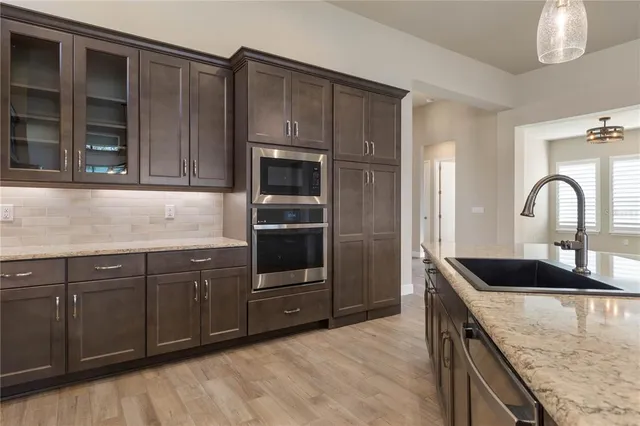 a view of hallway with a floor to ceiling window and wooden floor