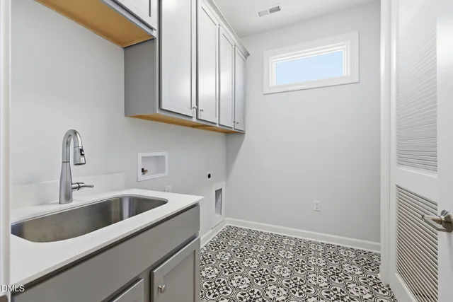 a view of a sink and dishwasher with wooden floor