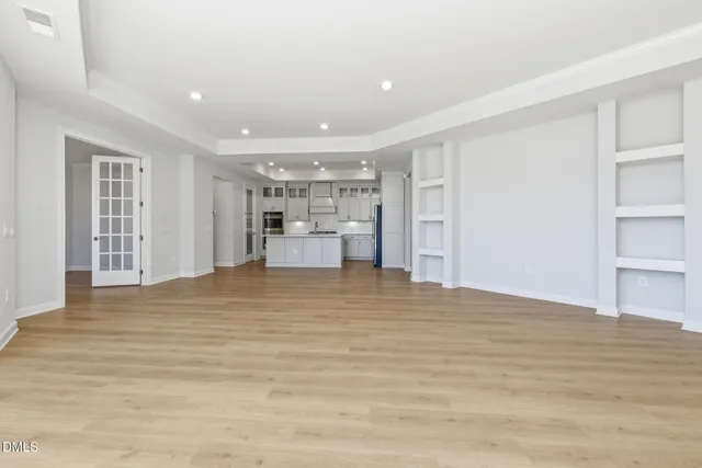 a view of empty room with wooden floor