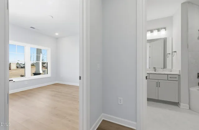 a view of a walk in closet and a bathroom