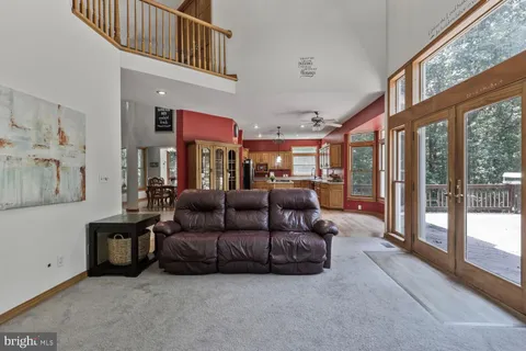 a living room with furniture and a floor to ceiling window