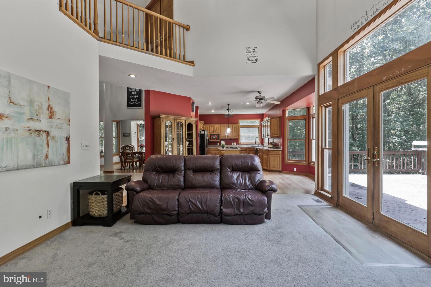 1761 Buckner Road Bumpass, VA 23024 - Photo 14 of 43 a living room with furniture and a floor to ceiling window