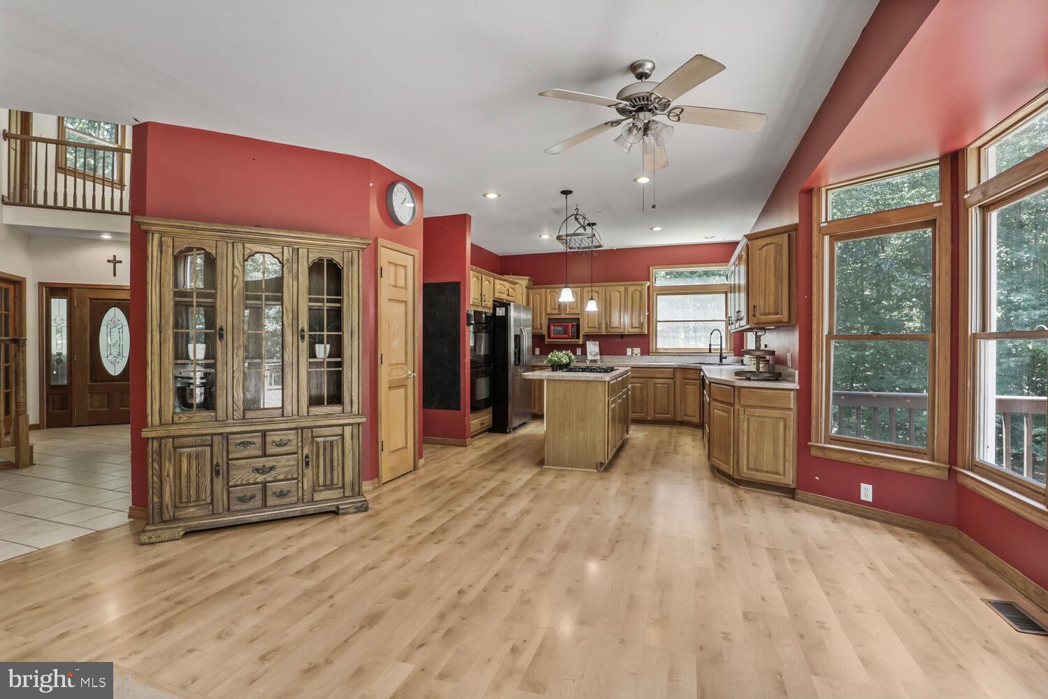 1761 Buckner Road Bumpass, VA 23024 - Photo 15 of 43 a view of a kitchen with granite countertop a refrigerator a oven a sink and dishwasher with wooden floor