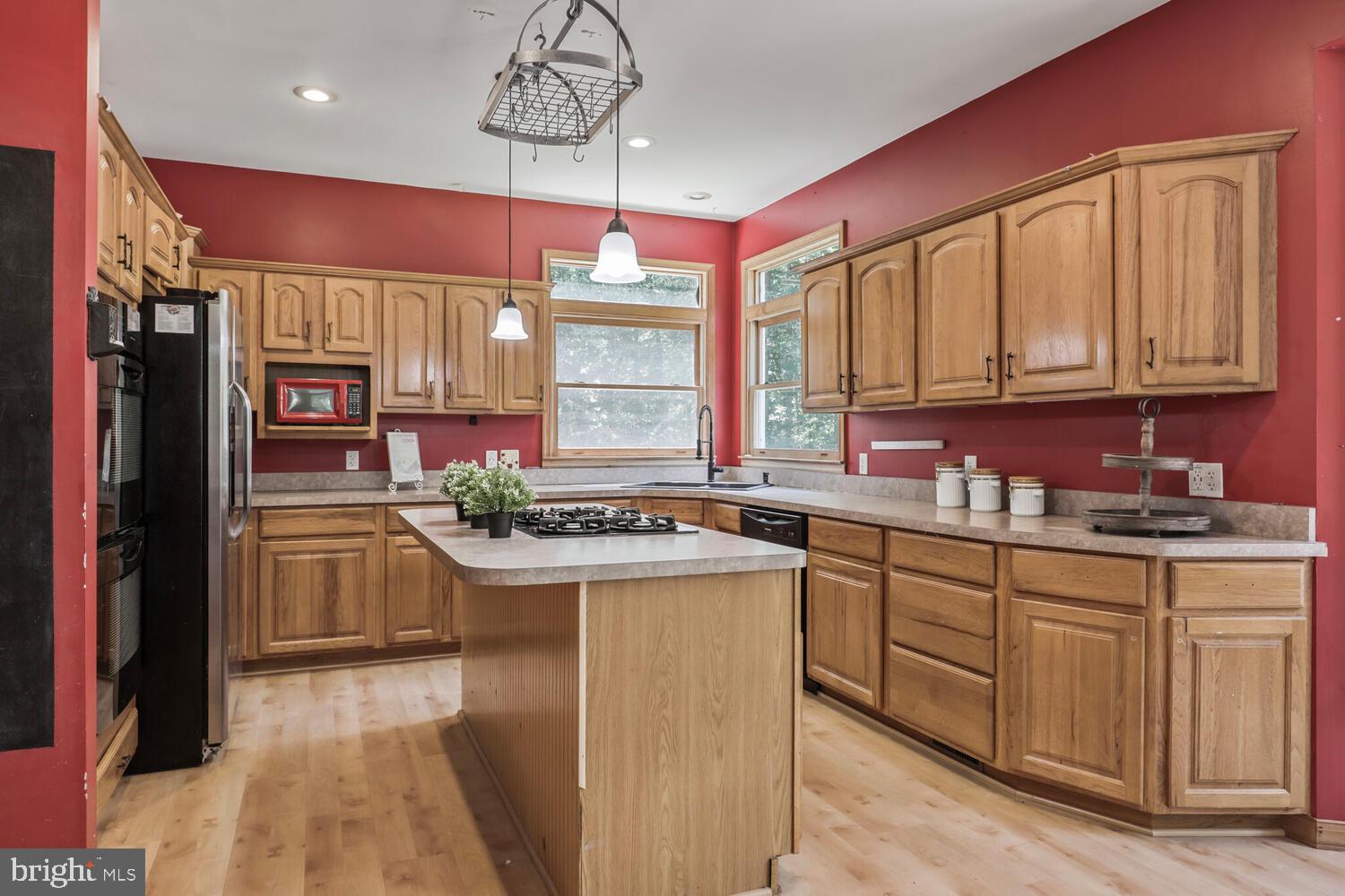1761 Buckner Road Bumpass, VA 23024 - Photo 21 of 43 a kitchen with kitchen island granite countertop a sink cabinets and stainless steel appliances