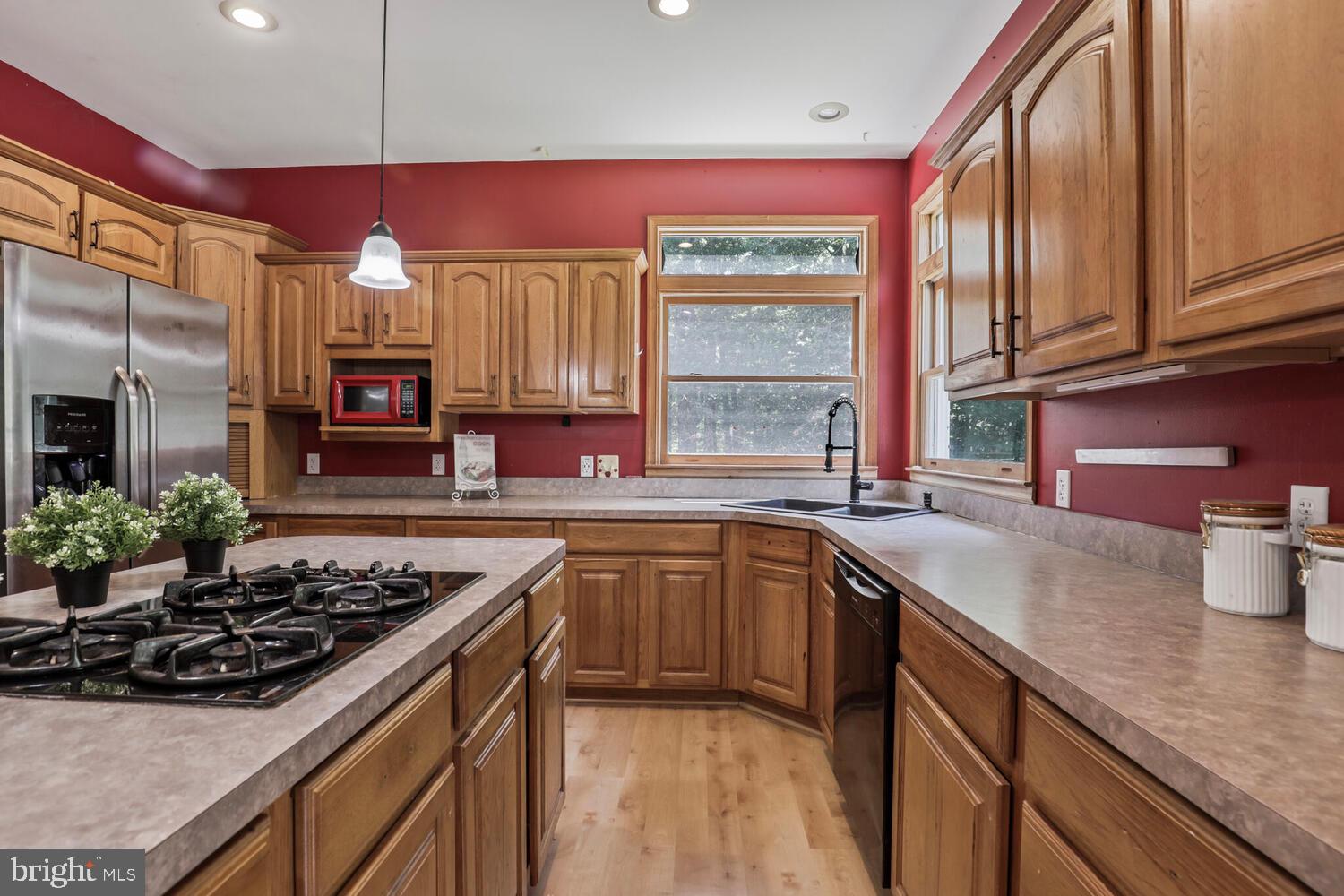 1761 Buckner Road Bumpass, VA 23024 - Photo 22 of 43 a kitchen with stainless steel appliances granite countertop a sink stove and refrigerator