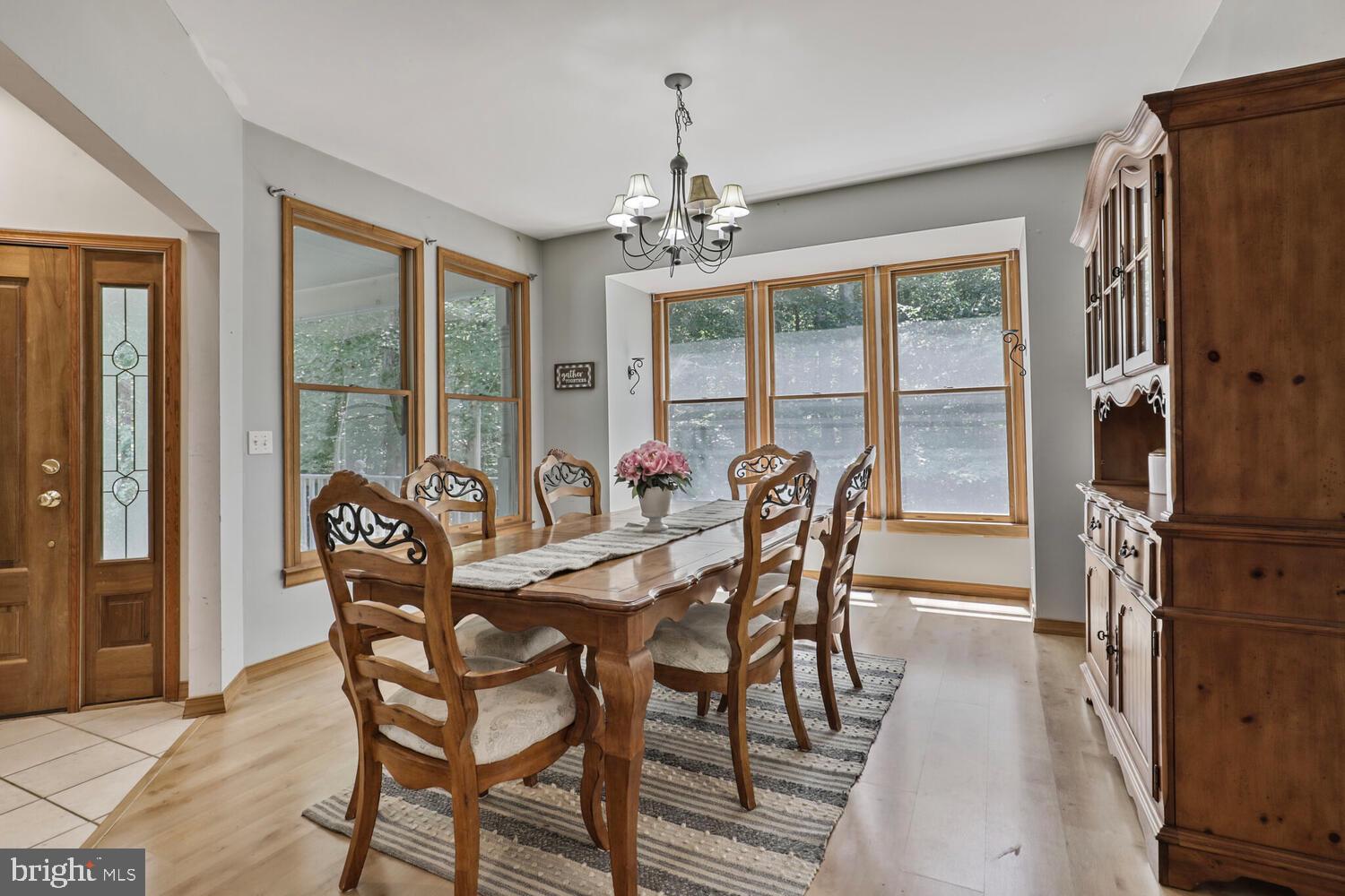 1761 Buckner Road Bumpass, VA 23024 - Photo 23 of 43 a view of a dining room with furniture large windows and wooden floor