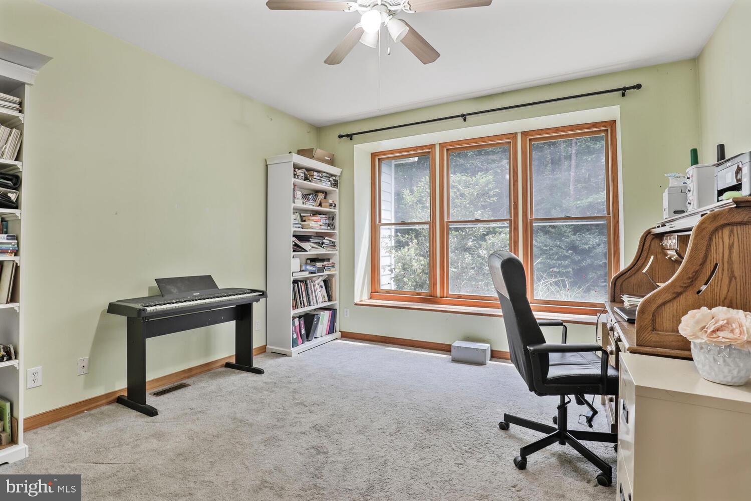 1761 Buckner Road Bumpass, VA 23024 - Photo 26 of 43 a view of a workspace with furniture and a window
