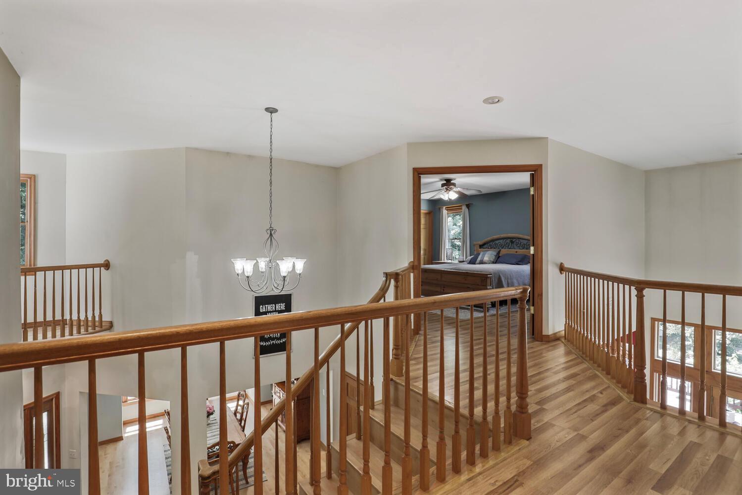 1761 Buckner Road Bumpass, VA 23024 - Photo 28 of 43 a view of a hallway with wooden floor and stairs