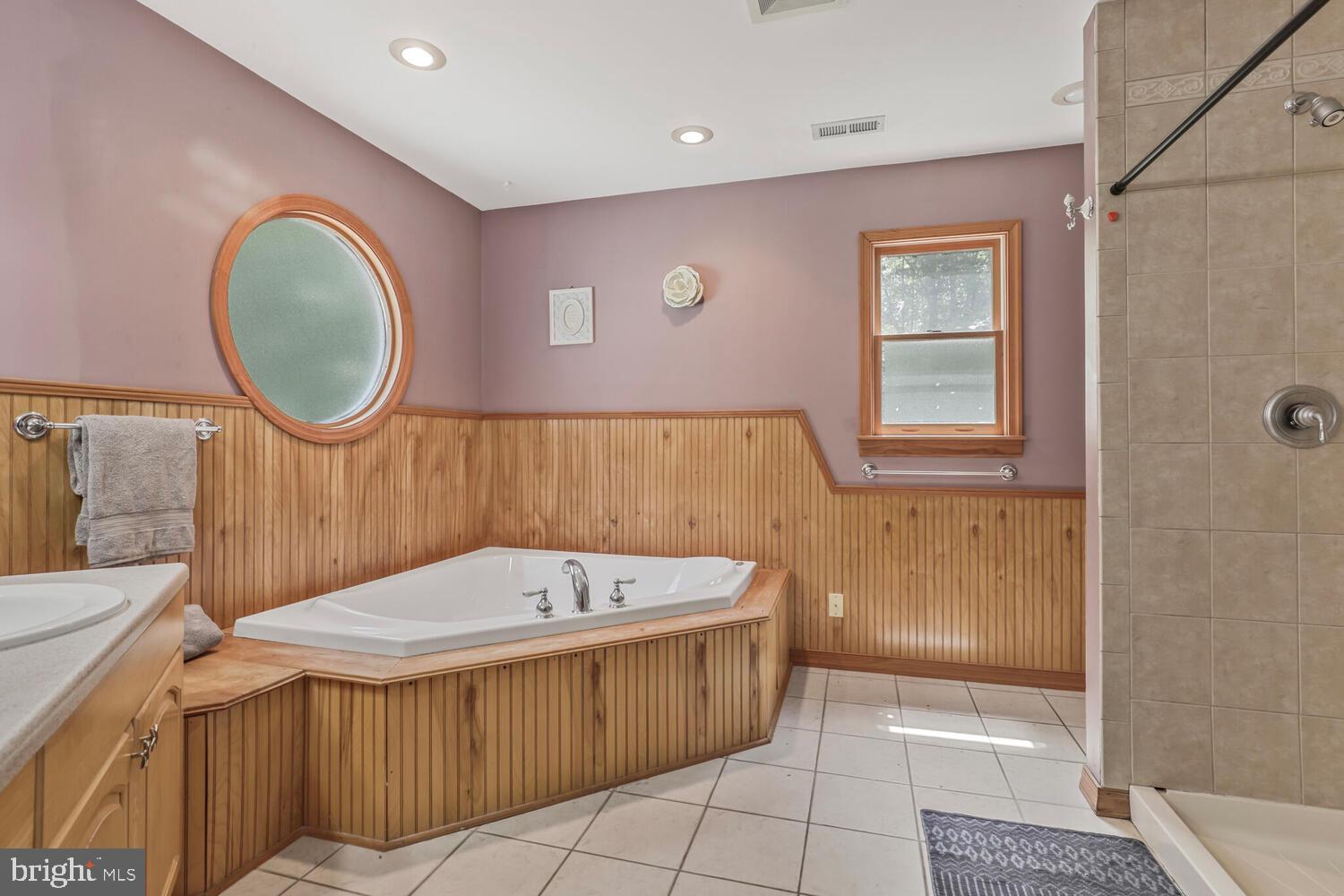 1761 Buckner Road Bumpass, VA 23024 - Photo 35 of 43 a bathroom with a tub a sink and a mirror