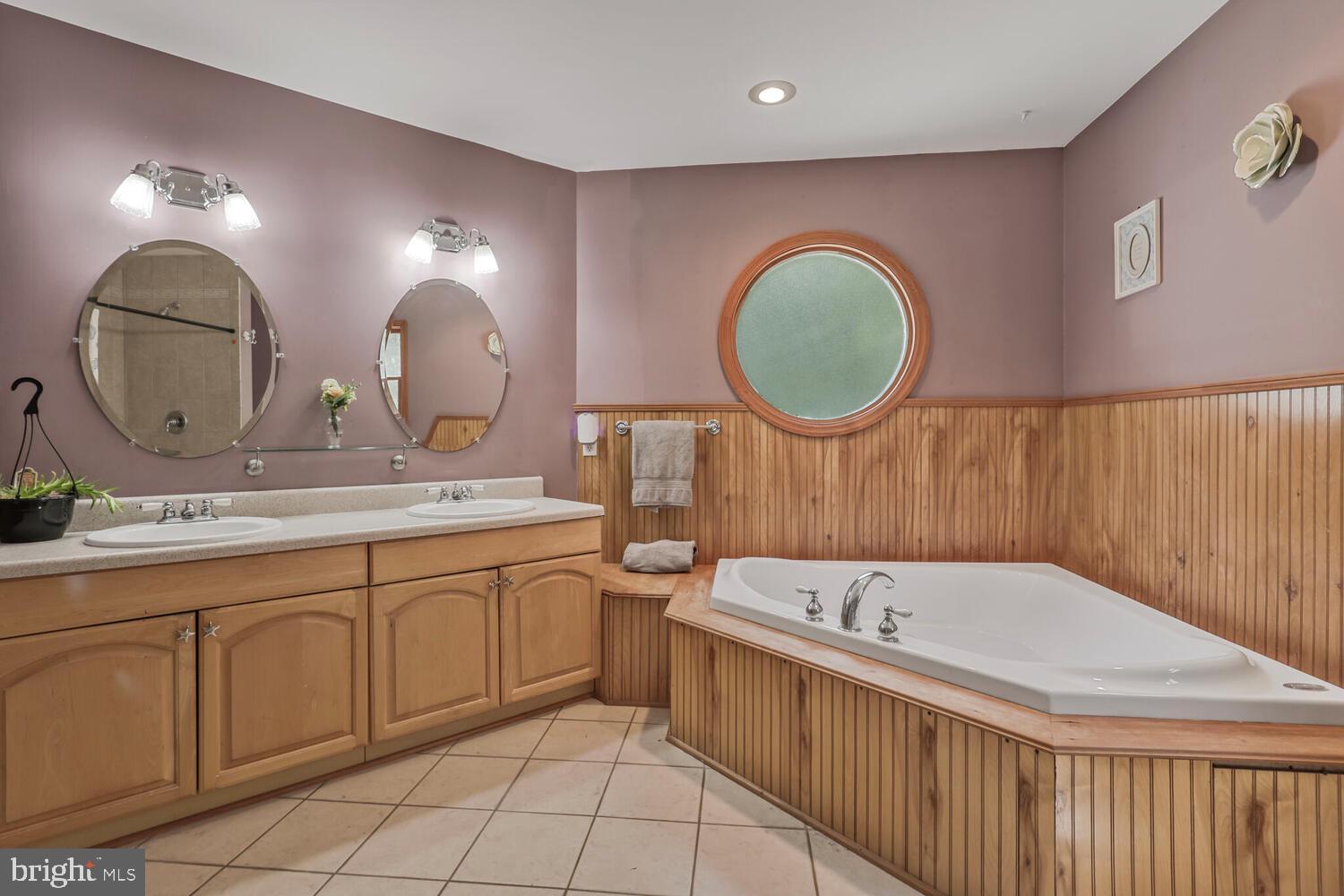 1761 Buckner Road Bumpass, VA 23024 - Photo 36 of 43 a bathroom with a double vanity sink mirror and bathtub