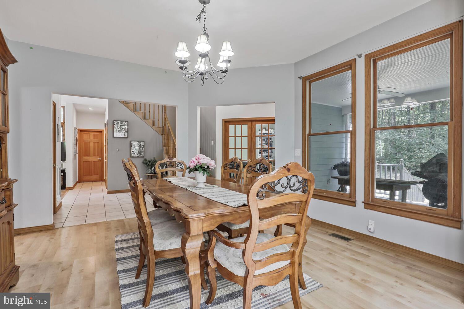 1761 Buckner Road Bumpass, VA 23024 - Photo 6 of 43 a view of a dining room with furniture wooden floor and chandelier