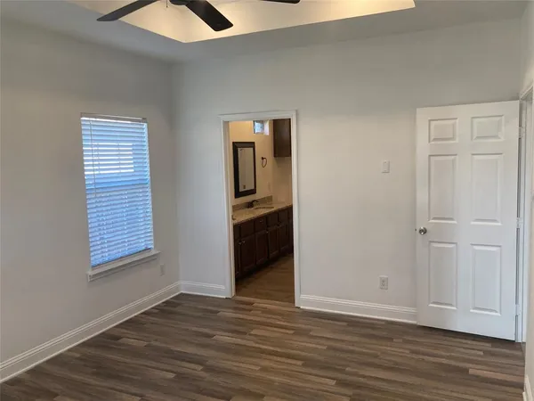 a view of a room with wooden floor and windows