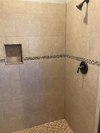 a bathroom with a shower and a sink