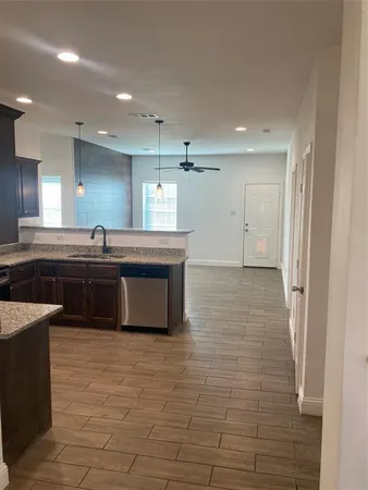 a kitchen with a sink and a stove top oven