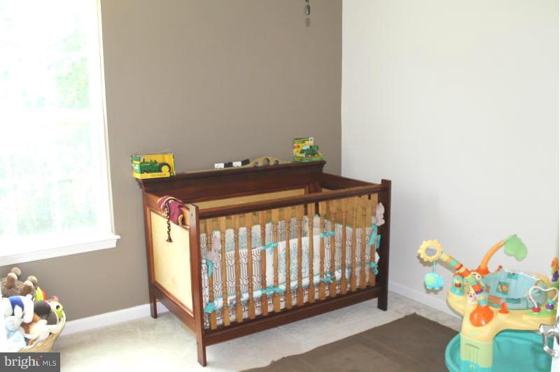 2630 St Marys View Road Accokeek, MD 20607 - Photo 17 of 25 a bedroom with a bed and toys