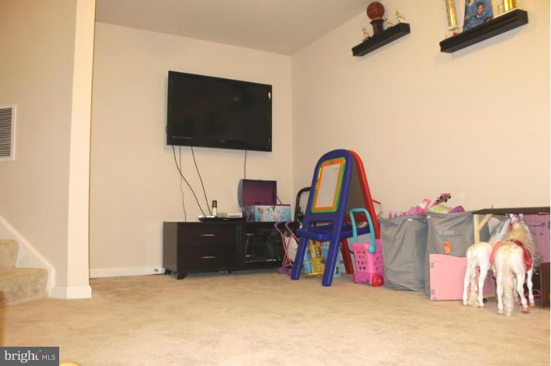 2630 St Marys View Road Accokeek, MD 20607 - Photo 19 of 25 a living room with furniture and a flat screen tv