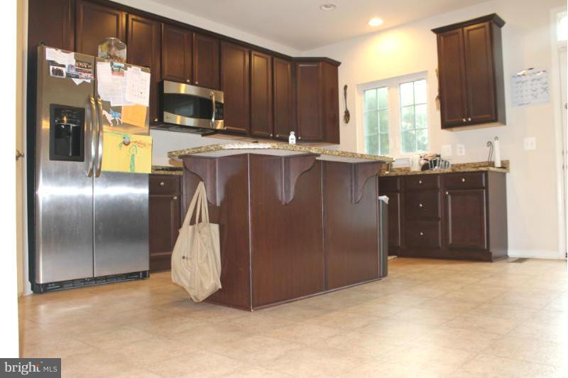 2630 St Marys View Road Accokeek, MD 20607 - Photo 4 of 25 a kitchen with stainless steel appliances granite countertop a refrigerator a stove a sink and a oven
