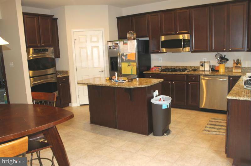 2630 St Marys View Road Accokeek, MD 20607 - Photo 5 of 25 a kitchen with a refrigerator and a stove top oven