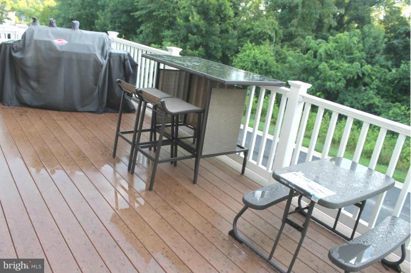 2630 St Marys View Road Accokeek, MD 20607 - Photo 7 of 25 a balcony with wooden floor table and chairs