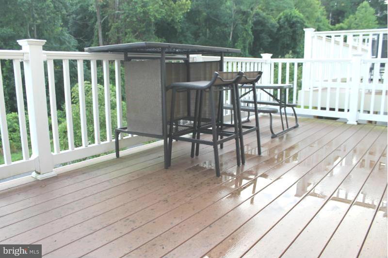 2630 St Marys View Road Accokeek, MD 20607 - Photo 8 of 25 a view of a patio with a table chairs and wooden floor
