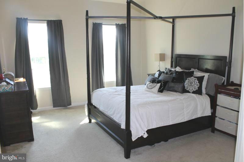 2630 St Marys View Road Accokeek, MD 20607 - Photo 9 of 25 a bedroom with a bed and a mirror