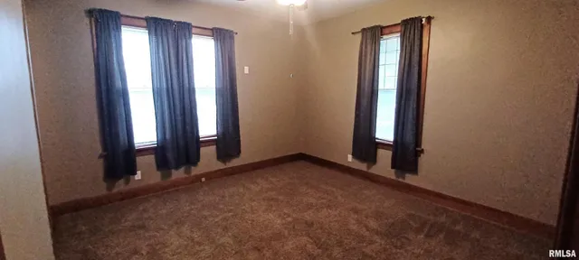 an empty room with closet area