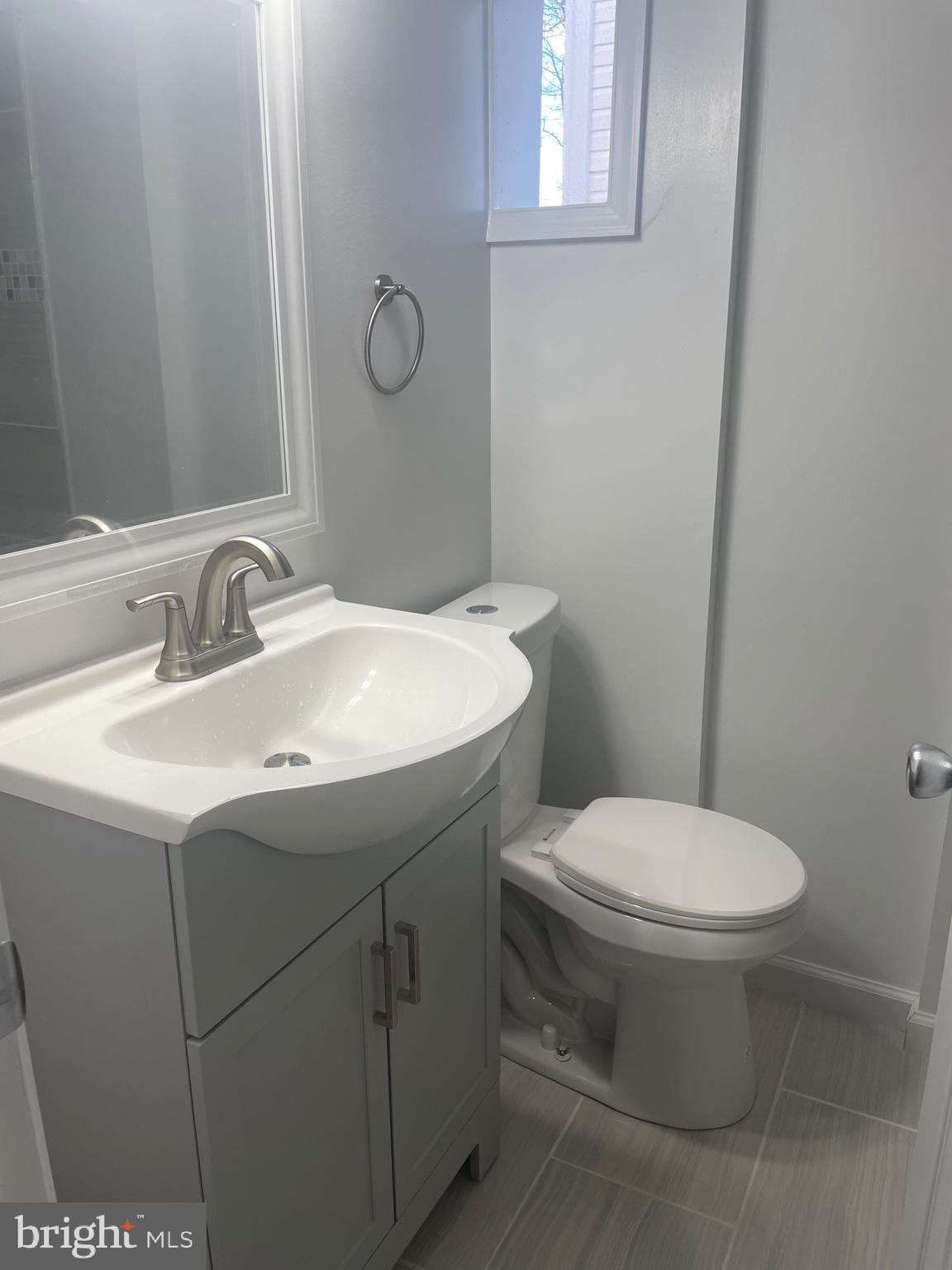 6107 Buckler Road Clinton, MD 20735 - Photo 23 of 45 a bathroom with a sink toilet and mirror