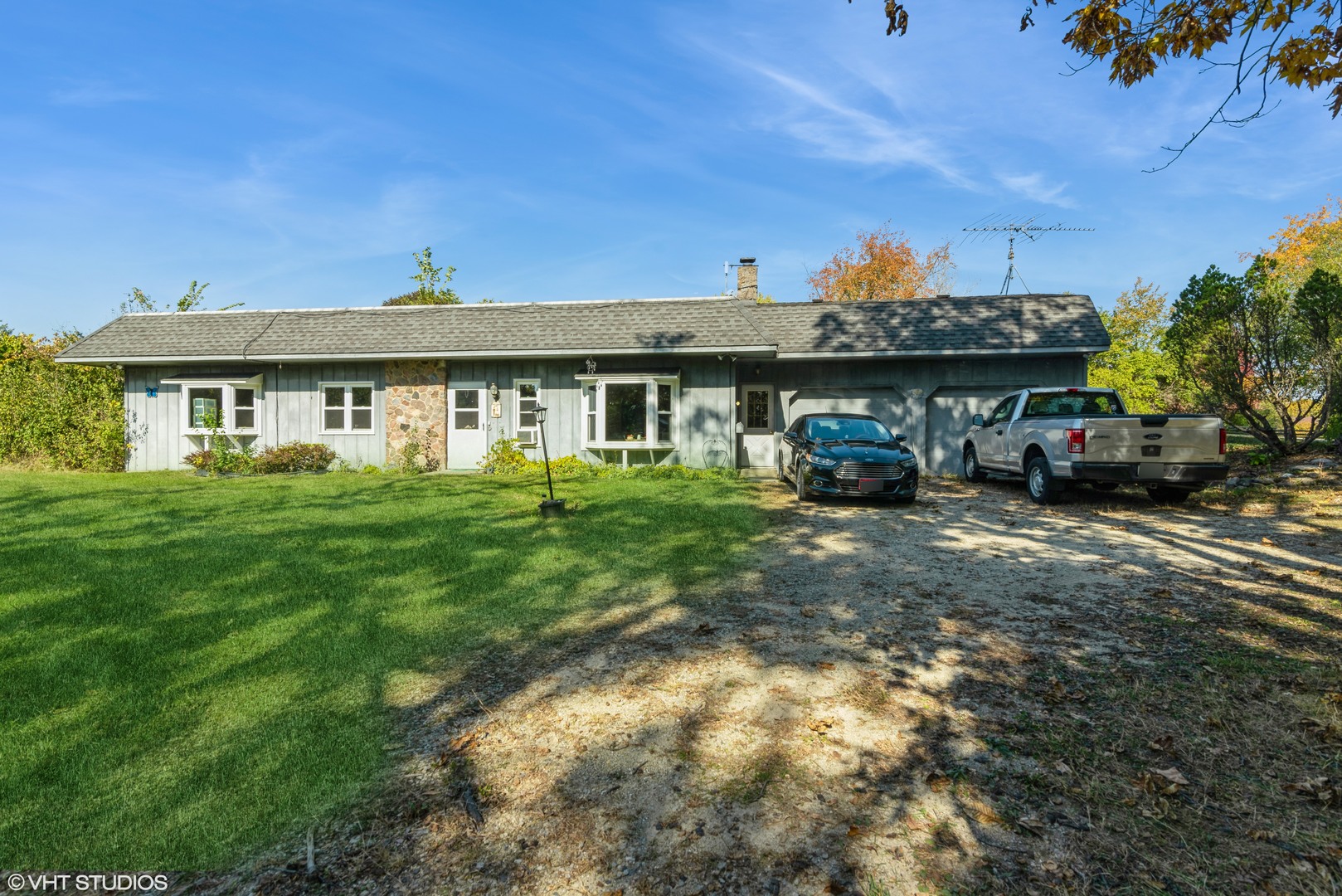 6519 Rowland Road Huntley, IL 60142 - Photo 3 of 12 a front view of a house with a garden