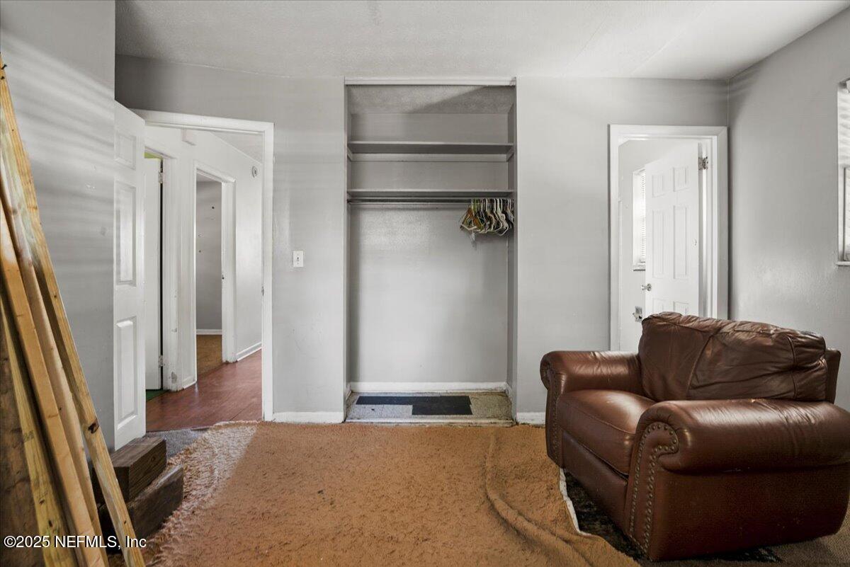 8514 Oak Leaf Road Jacksonville, FL 32208 - Photo 15 of 23 a living room with furniture and a rug