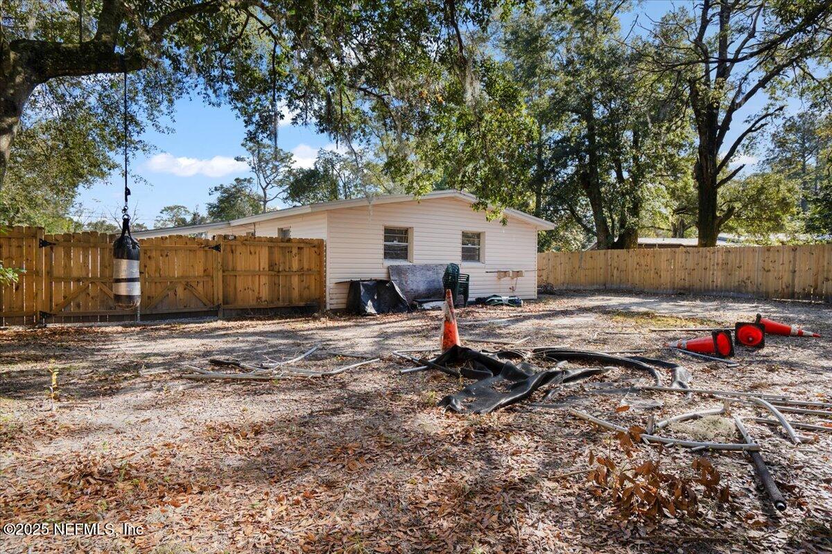 8514 Oak Leaf Road Jacksonville, FL 32208 - Photo 23 of 23 a view of a backyard with a bench and wooden fence
