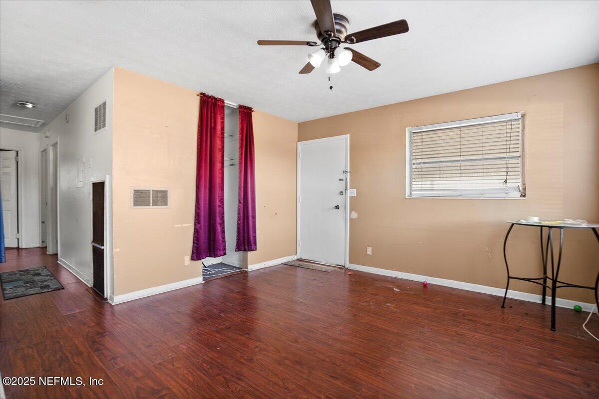 8514 Oak Leaf Road Jacksonville, FL 32208 - Photo 5 of 23 a view of a livingroom with wooden floor and a ceiling fan