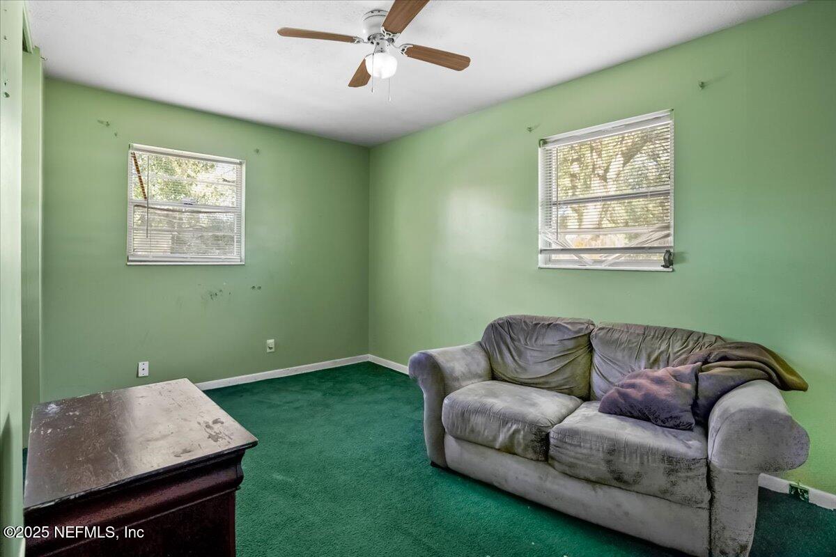 8514 Oak Leaf Road Jacksonville, FL 32208 - Photo 10 of 23 a living room with furniture and a window