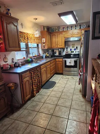 a kitchen with stainless steel appliances granite countertop a sink and cabinets